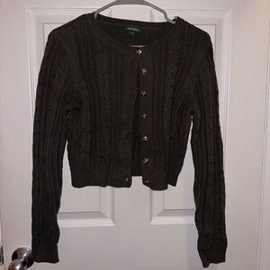 Cable knit cropped green cardigan.